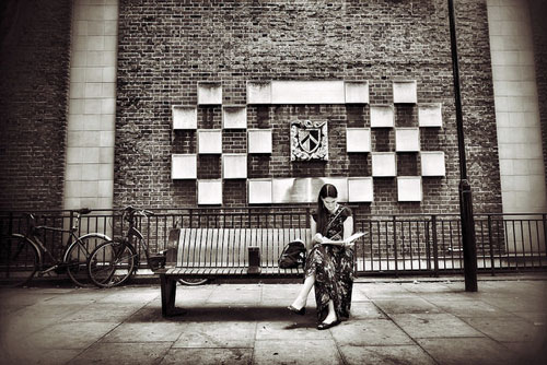 woman reading on bench